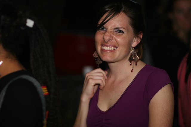 Joyful Woman Smiling at Evening Social Gathering