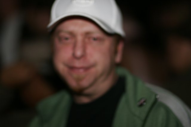 Blurry Man in White Cap