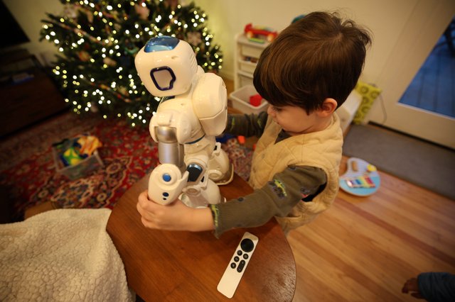 Child Interacting with Humanoid Robot on Christmas Morning
