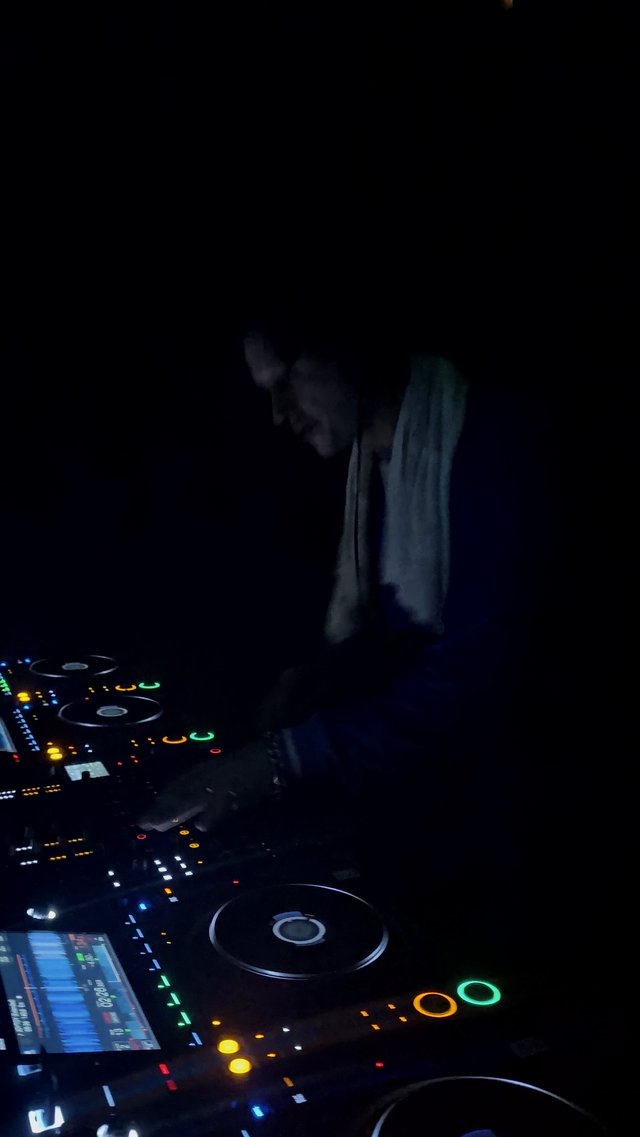 DJ Performing with Pioneer Equipment in Dark Club