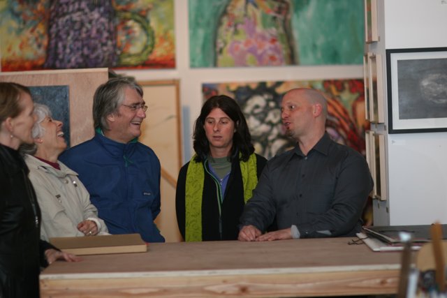 Art Enthusiasts Admire Wood-Framed Paintings