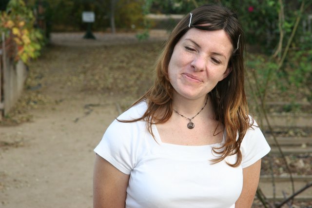 Young Woman Smiling Playfully in Outdoor Park Setting