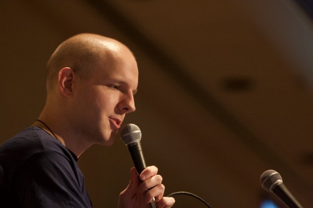 Bald Entertainer Performing with a Microphone