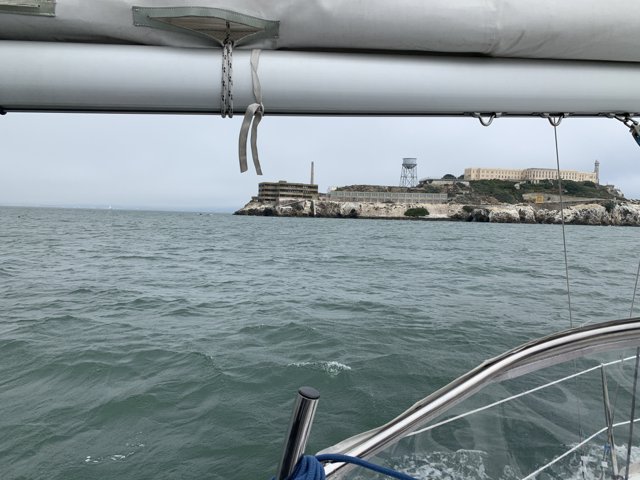 Sailboat sailing towards Alcatraz Island Lighthouse