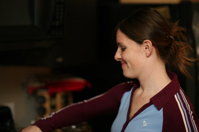 Woman Smiling in Profile at Indoor Gathering