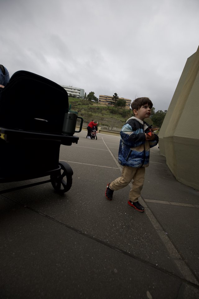 Young Boy Walking on Campus Promenade