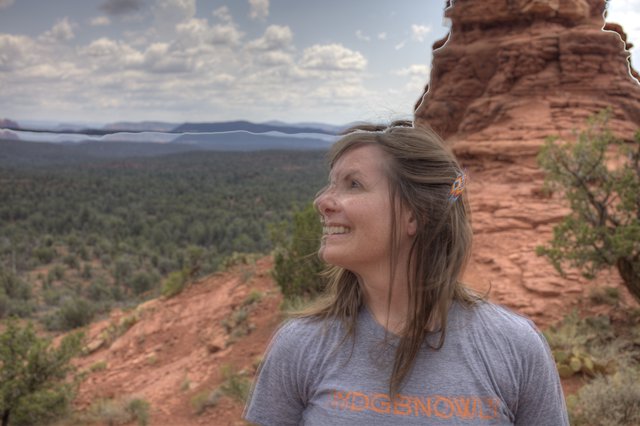 Woman Smiling Atop Red Rock Formation in Sedona