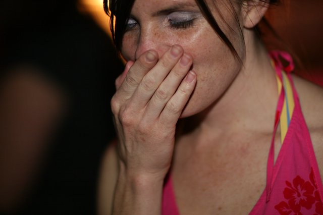 Woman in Distress Covering Her Mouth at Night