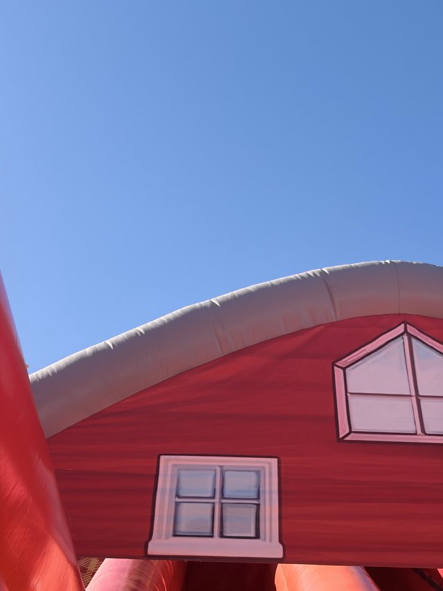 Inflatable Pink House Bouncer Against Blue Sky