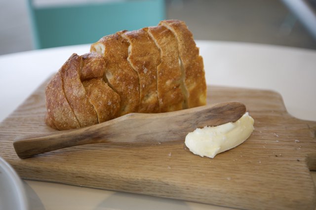 Artisan Bread with Butter on Wooden Board