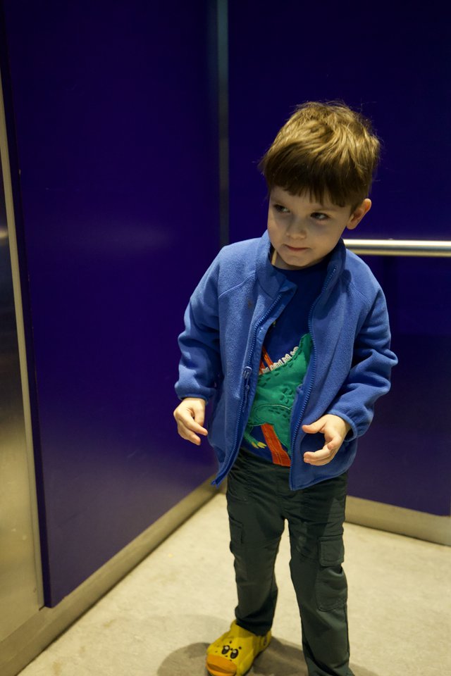 Young Boy in Blue Jacket at Science Center