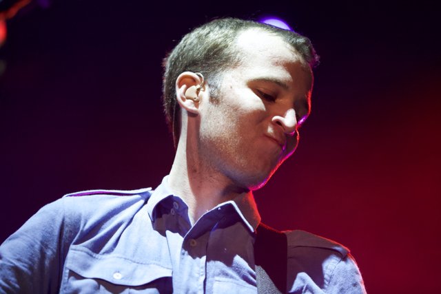 Blue Shirted Chris Baio Electrifies the Stage with his Music