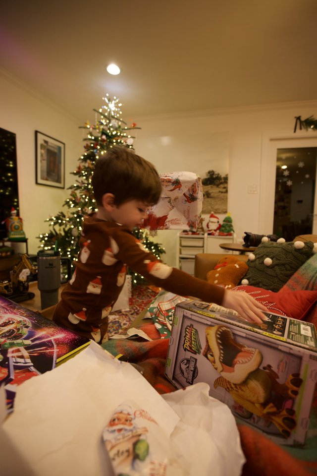Child Opening Christmas Presents on Holiday Morning