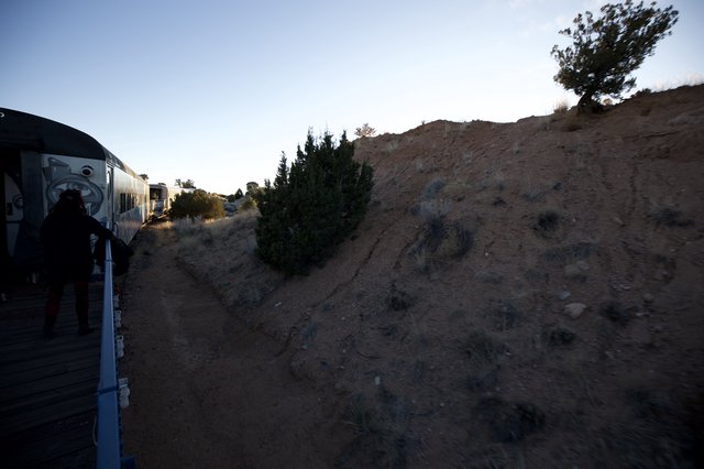 Sunset Train Journey Through Desert Landscape