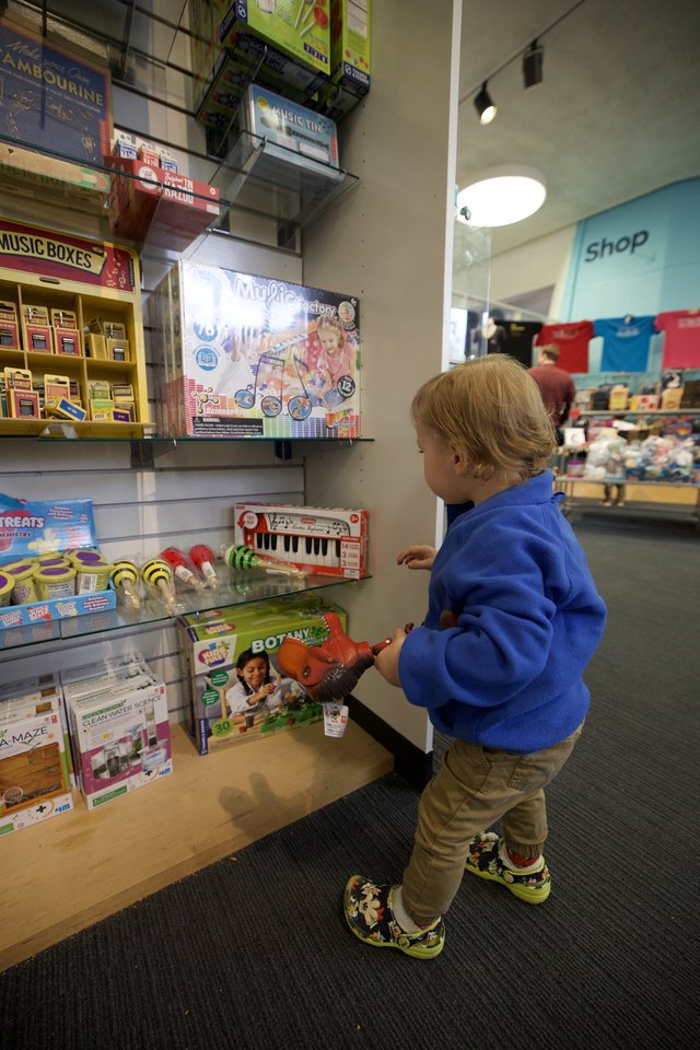 Young Child Browsing Music Toys at Museum Gift Shop