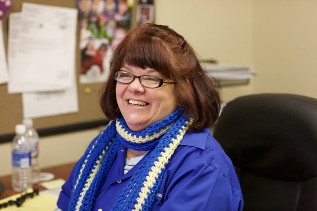 Portrait of a Happy Woman with Blue Scarf and Glasses