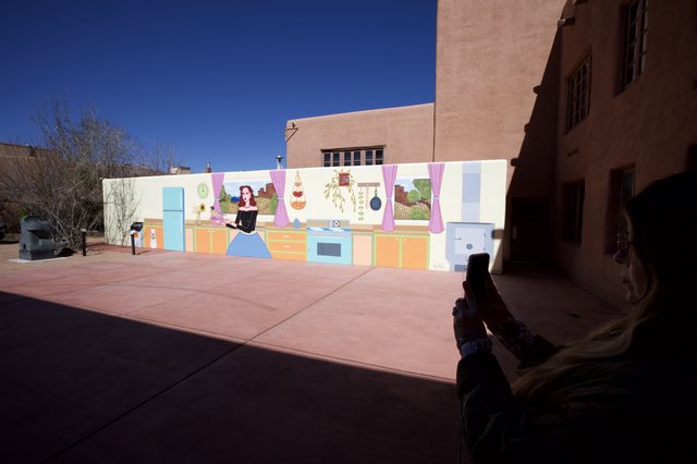 Tourist Photographing Colorful Kitchen Mural in Santa Fe