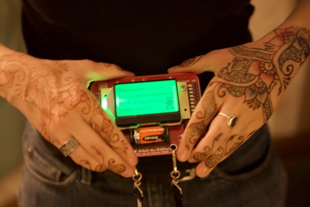 Tattooed Hand Holding Green Screen