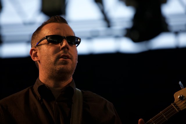 Man in sunglasses rocking out on stage