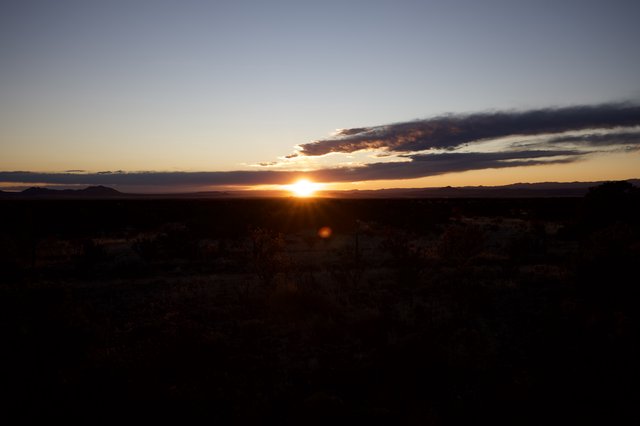 Desert Sunset Over Distant Mountain Ranges