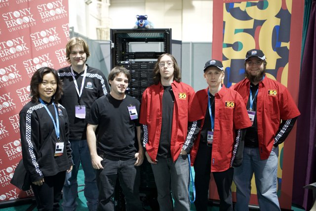 Group posing with super computer at Super Computing 07
