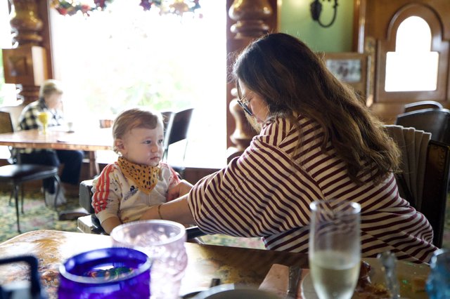 Mother and Child Sharing Mealtime at Restaurant Table