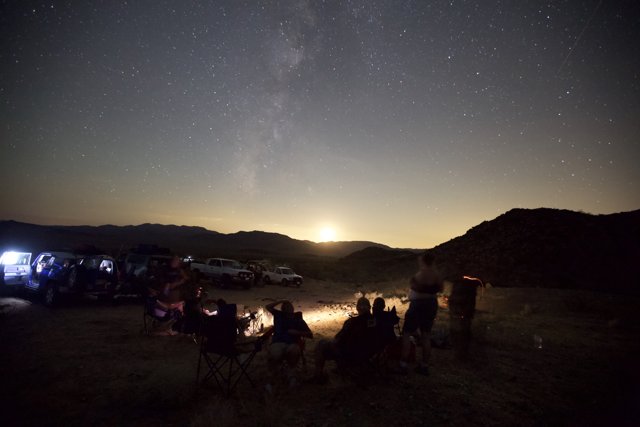 Campfire Silhouettes Under the Starry Night Sky