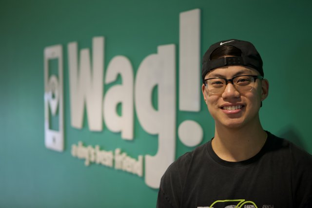 Ning Zetao Poses in Front of WAG Logo