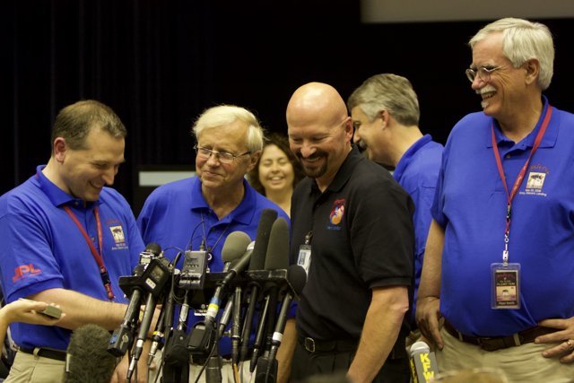 Blue Shirted Men in the Press Conference