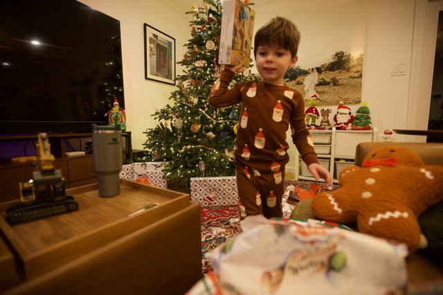 Child Opening Christmas Presents on Christmas Morning