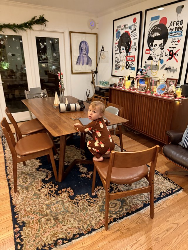 Toddler Standing on Chair in Mid-Century Modern Dining Room