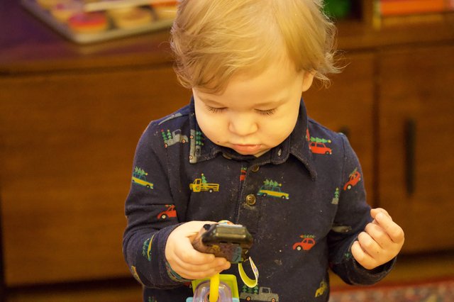 Toddler Playing with Toy Trucks on Christmas Eve