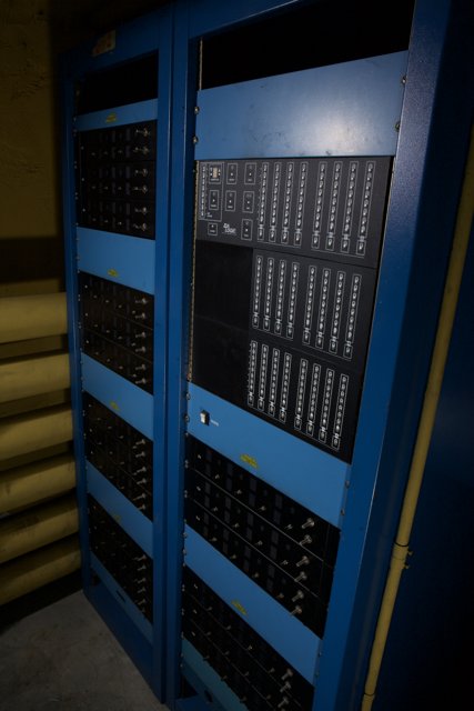 Blue computer rack with diverse hardware