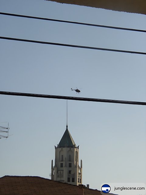 Helicopter Flying over Clock Tower Building