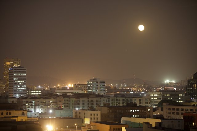 Nighttime Cityscape Under the Full Moon