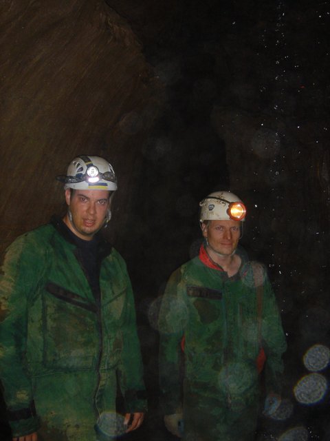 Two Men in Green Jackets Wearing Helmets
