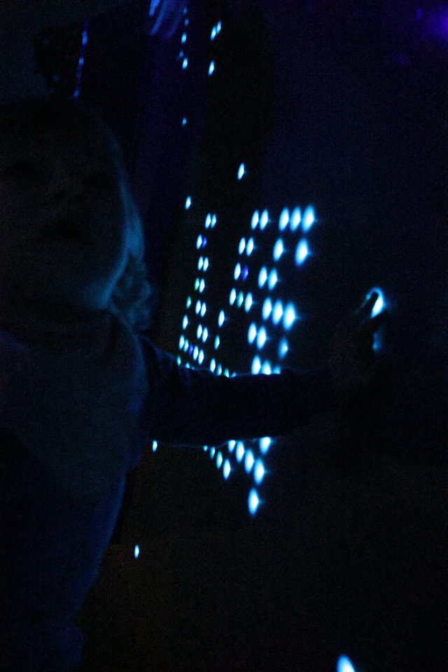 Blue Illuminated Perforated Pattern in Darkness