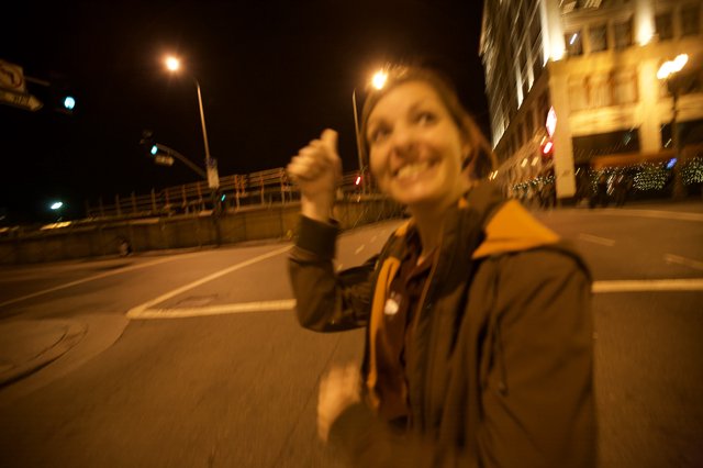 Jubilant Thumbs Up on Empty City Streets at Night