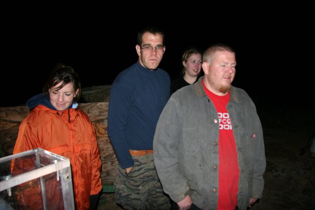 Group of Four at Nighttime Outdoor Gathering