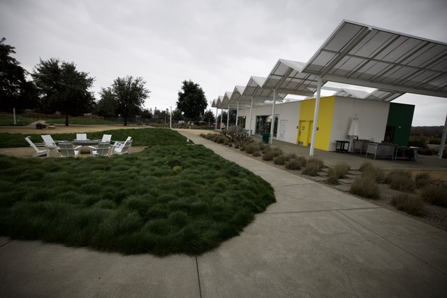 Modern Pavilion with Zigzag Roofline and Outdoor Seating