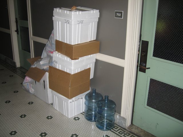 Stack of Boxes and Water Bottle on the Floor