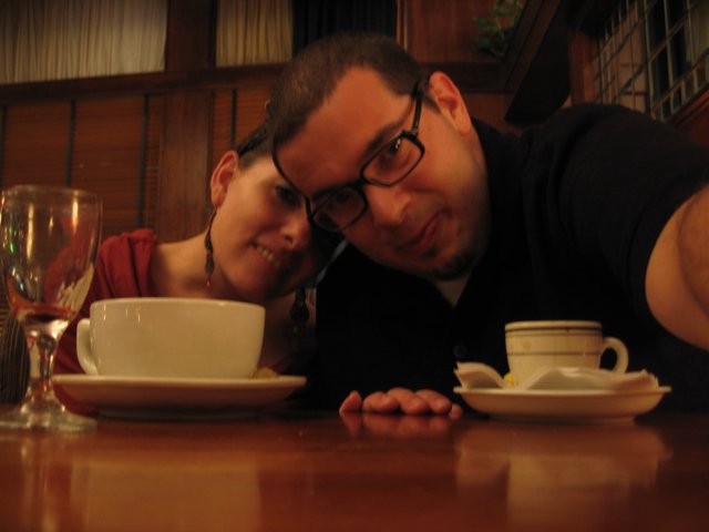 Couple Poses Cheek to Cheek at Restaurant Table