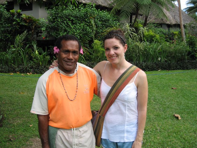 Smiling Travelers Pose at Tropical Resort Garden