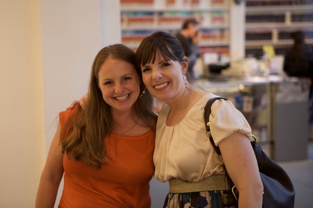 Two Women Smiling Together at Wine Party Event