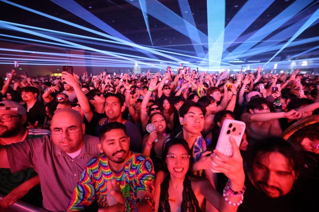 Massive Crowd Electrified Under Laser Light Show