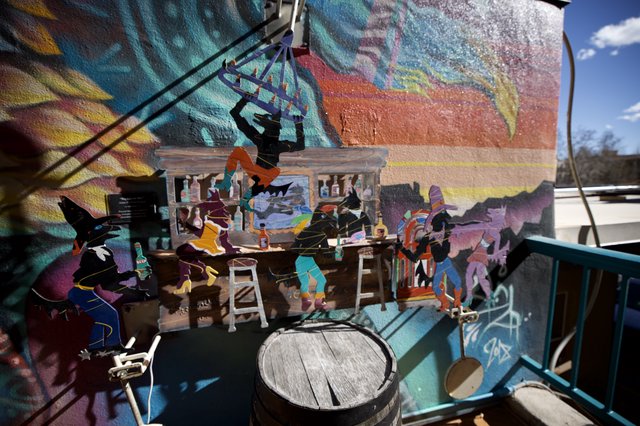 Layered Art Installation with Mural Backdrop at Bar Scene