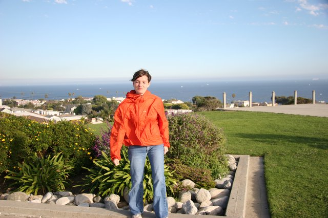 Woman in Orange Jacket Overlooking Coastal California Town