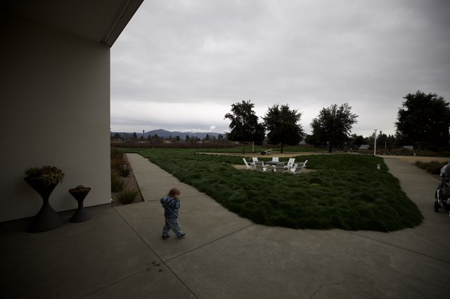 Child Walking Through Modern Patio at Dusk