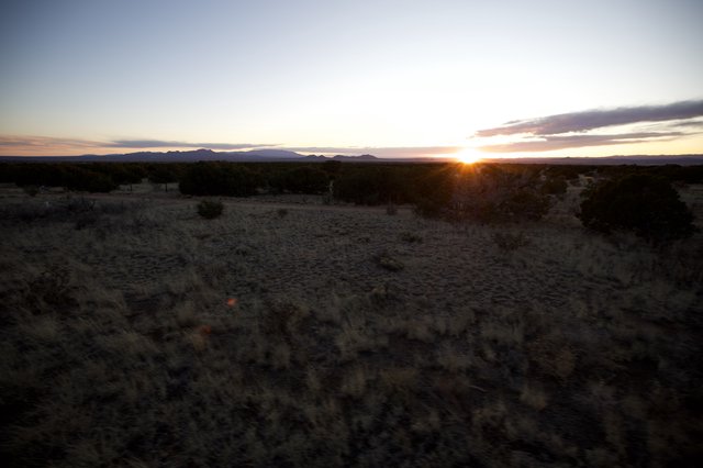Desert Sunrise Over Distant Mountain Range