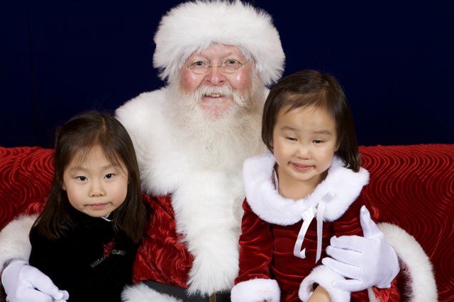 Santa Claus spreading Christmas cheer with little girls